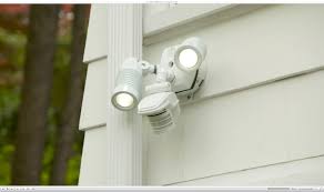Electrician installing sensor light safely London